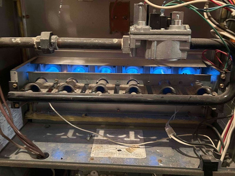 The gas furnace with blue lights was opened for repair in Edmonton, AB.