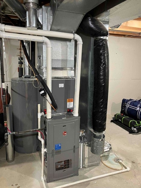 Modern high-efficiency furnace installed in an Edmonton mechanical room.